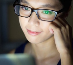 Woman look at computer screen at night